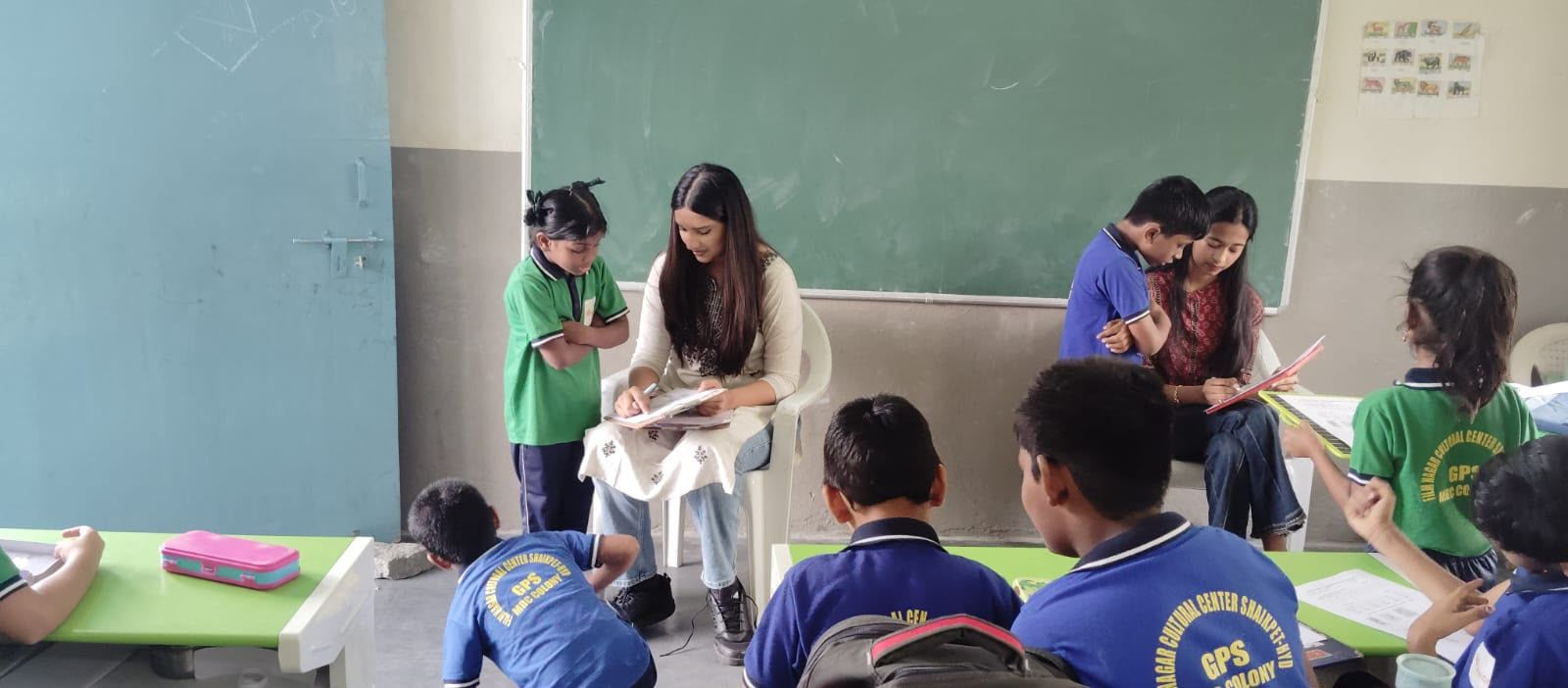 Ruthvika and Jasmitha conducting individual baseline reading assessments with students